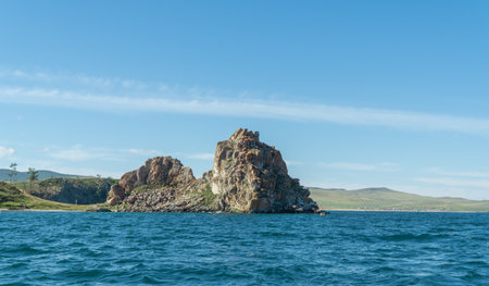Shamanka Rock on Olkhon. Cape Burhan. rock near the shore, view from the water. Beautiful landscape of Siberian Baikal Lake. concept of travel. Lake Baikal is the largest freshwater lake in the worldの写真素材