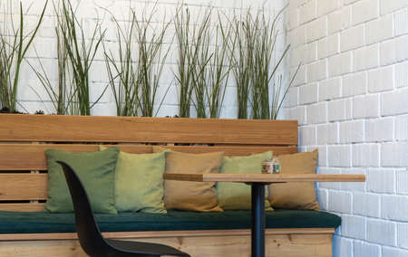 table and a wooden bench with pillows. interior of a room for eating.の写真素材