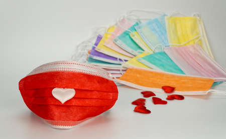 medical mask with a heart. Celebrating Valentines Day during a pandemic. gratitude to doctors for their workの写真素材