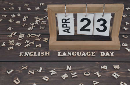 April 23, date on the calendar. English Language Day. Handmade wood cube with date month and day. Wooden letters on wooden background. english alphabet.の写真素材