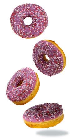 flying donuts isolated on white background. selective focus. multicolored crumpets. set of sweet donuts, traditional confectionery products. icing sugar with sprinkles.の写真素材