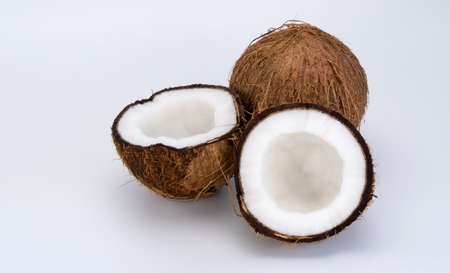 split and whole coconut on a white background. Coco, ripe palm fruit.