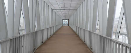 viaduct, pedestrian bridge across the street. selective focus. covered long tunnelの写真素材