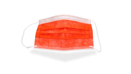 Medical sterile disposable mask, white background. Red surgical mask, cover the mouth and nose. respiratory bandage face. personal protective equipment. antiviral filter against respiratory diseasesの写真素材