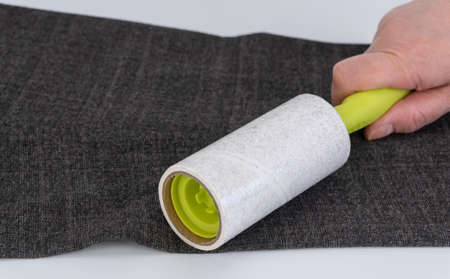 reusable sticky roller for cleaning clothes. selective focus. Designed to remove dust, wool, lint from any type of fabric. Cleans the surface without leaving traces, rotates easily.の写真素材
