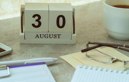 August 30, date on the calendar. Handmade wood cube with date month and day. planning for the day. artistic coloring. selective focus.の写真素材
