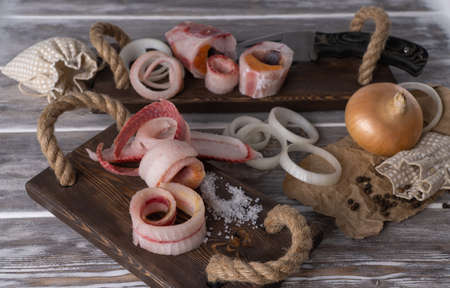 sliced frozen fish. selective focus. raw frozen fish cut into shavings on a wooden background. Stroganina, one of the main dishes of northern cuisine. Planked fish.の写真素材