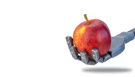 fingers squeeze a fresh apple in the robots hand. future technologies and ecology. robotics applicable in agriculture and natural products trade. artificial intelligence and nature.の写真素材