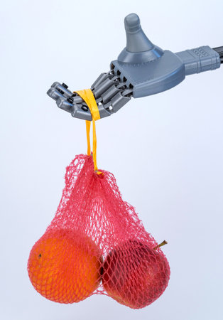 robot hand holds a grid of fruits. food delivery using technology and artificial intelligence.の写真素材