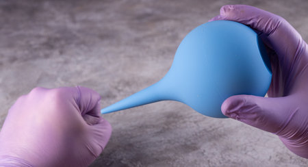 hands holding a medical enema. medical proceduresの写真素材
