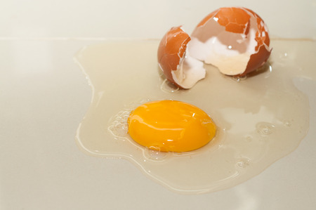 Cracked egg on cotton floor