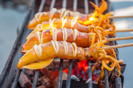 BBQ Squid on a Stick. grilled buttered fresh squidの写真素材