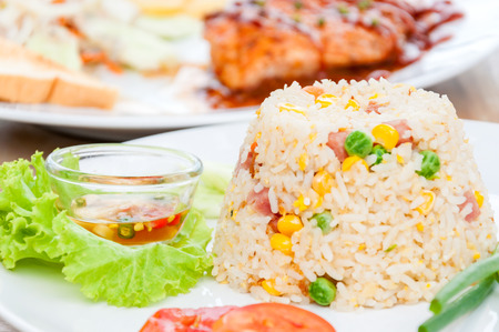 colorful fired rice on white plateの写真素材