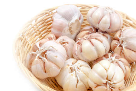 Fresh organic garlic in bamboo basket Isolate on whiteの写真素材