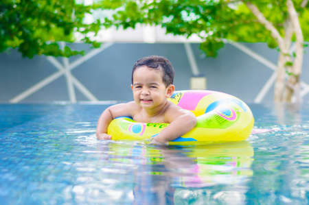 Boy in the outdoor swimming poolの写真素材