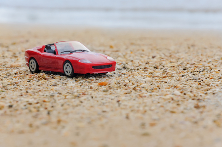 red toy car on beachの写真素材