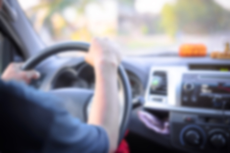 Defocused of young man driving a carの写真素材
