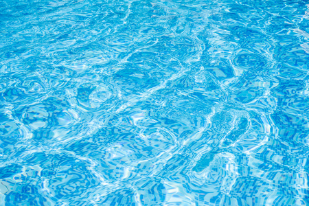 Abstract water wave, sun reflections in pool waterの写真素材