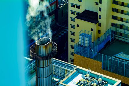 Smoke at the chemney in the urban city in Tokyoの写真素材