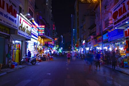 A night neon street at Ben Thanh market in Ho Chi Minh Vietnam wide shot