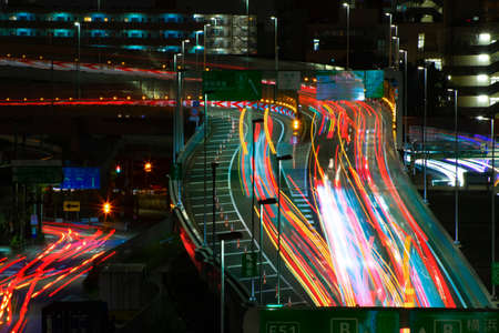 A night timelapse of the traffic jam at the urban street in Tokyo long shot