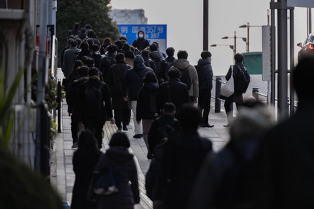 A crowd of walking people on the city street