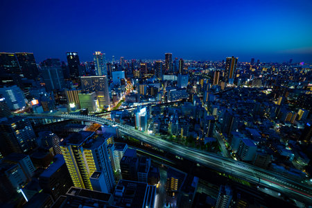 A dusk panorama cityscape near the railway in Osaka wide shotの写真素材