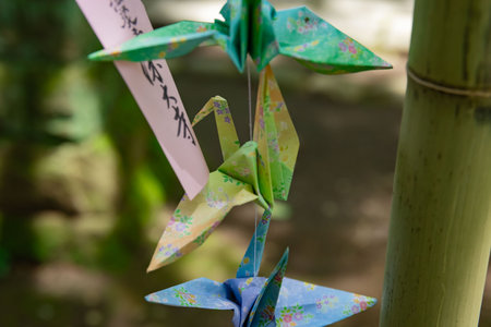A paper crane swaying in the wind at the traditional street close upの写真素材