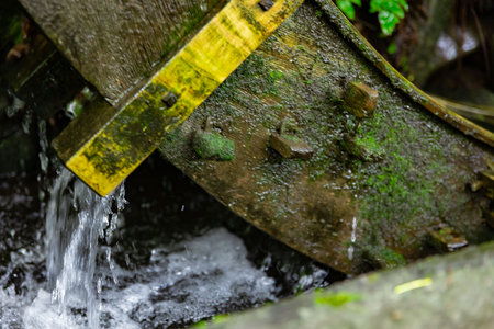 A historic wooden wheel on the water surface in Tokyo close up