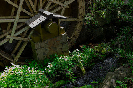 A historic wooden wheel on the water surface in Tokyoの写真素材