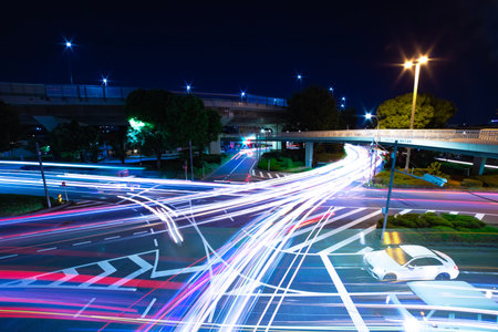 A night timelapse of traffic jam at the city intersection in Tokyo wide shotの写真素材