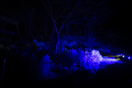 A panoramic landscape of colorfully illuminated icicles at night