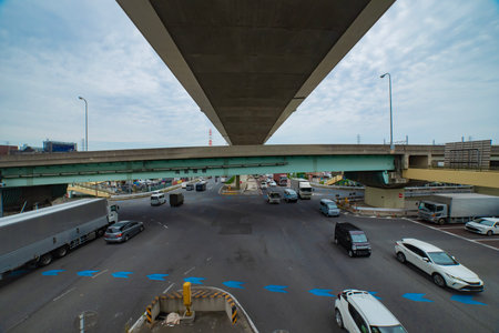 A cityscape of traffic jam at the downtown crossing under the overpass wide shot