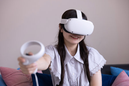 A Japanese woman playing with VR glass in the roomの写真素材