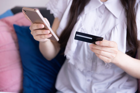 Japanese woman online shopping by card and smartphone in the