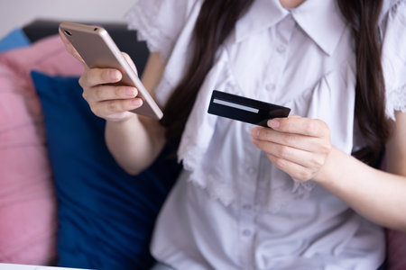 Japanese woman online shopping by card and smartphone in the