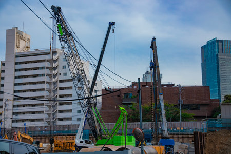 A cityscape of moving crane at the under construction in Tokyoの写真素材