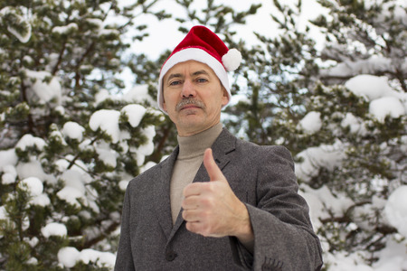 close-up of a businessman in winter suit in the forestの写真素材
