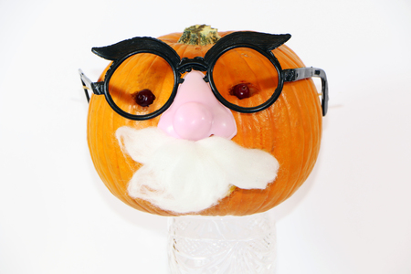 pumpkin dressed in santa claus with a gift for a childの写真素材