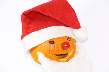 pumpkin dressed in santa claus with a gift for a childの写真素材