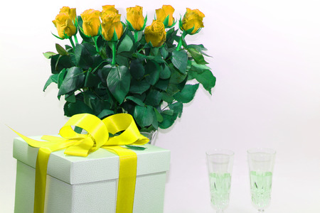 close up - gift box with red ribbon on red roses backgroundの写真素材