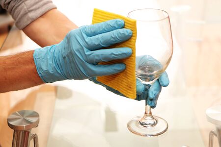 Cleaning the worker in blue gloves with an antibacterial solution. Disinfection of the room from...