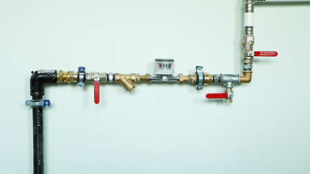 Construction of new water pipes. New water pipes and valves on the wall. Bathroom renovation.