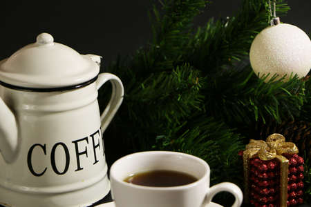 A cup of coffee on the table against the background of New Year's decor. Cup of coffee with...