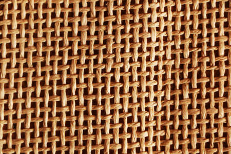 Abstract background from a fibrous fabric with a different color base. Burlap background.の写真素材