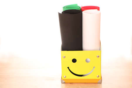 Yellow paper box with multi-colored background for photographing. Bright box for documents on the...