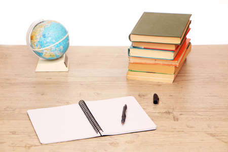 There is a globe and study materials on the table in the library to prepare for exams. Classroom...