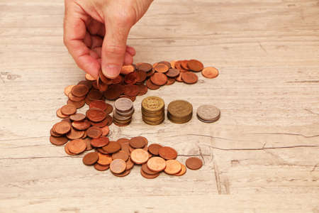 Saving money concept preset. A man's hand is counting money for a report in the office.の写真素材