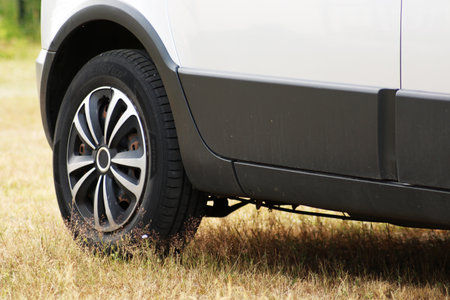 Front wheel of a passenger car close-up. Automotive wheel caps. Car tuning.の写真素材