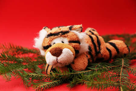 Tiger as a symbol of 2022, Christmas and New Year. Festive decorations for the new year and christmas. Christmas festive decor with a tiger on a red background.の写真素材